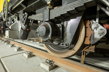 Closeup of the railway maintenance vehicle. Train wheels on rails.