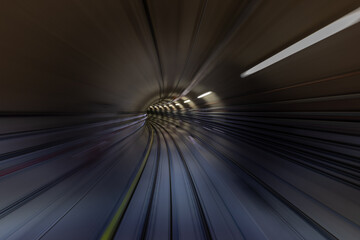 Construction site of the subway tunnel with blurred light tracks. Underground facility leading deep...