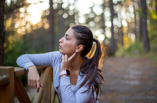 Tired Woman Is Checking Her Heart Rate After Training In The Park.