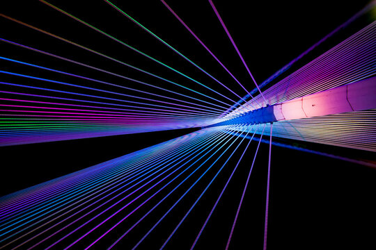 colourful and abstract view of modern suspension bridge architecture during the night