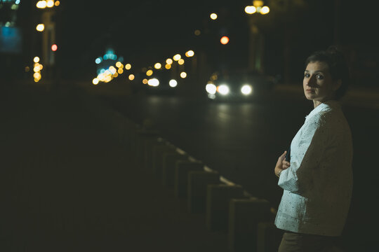 Young beauty woman wearing white jacket walking at the road. woman waiting  for a taxi - Powered by Adobe