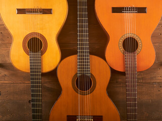 Fototapeta na wymiar classical guitars in wooden background