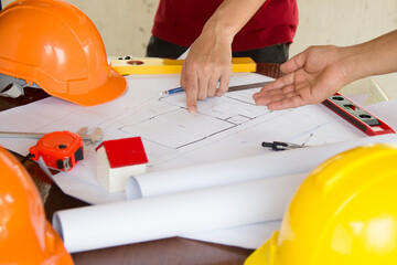 team Engineer and Architect consult projct with blueprint  at Construction Site