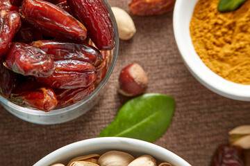 Various raw nuts: hazelnuts, pistachios, chestnuts, dates and oranges.