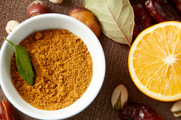Various raw nuts: hazelnuts, pistachios, chestnuts, dates and oranges.