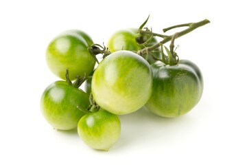Bundle of unripe green tomatoes over white background