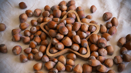 Raw hazelnuts on bamboo star shape plate. High quality photo