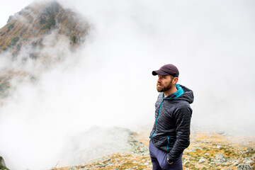 handsome male hiker in foggy mountains social distancing