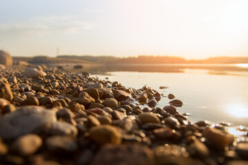stones by the lake sunset