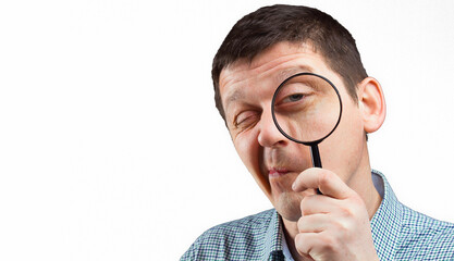 a man looking through a magnifying glass