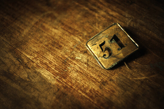 Vintage tag with the number 51 on a wooden background