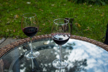 
Glasses with red wine on a transparent glass table
