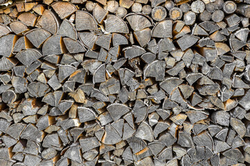 Firewood is lying in a woodpile close-up. Wood texture
