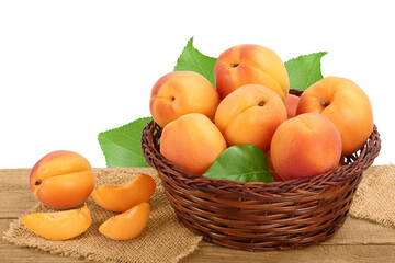 apricot fruit in Wicker basket on wooden table isolated on white background. Clipping path and full depth of field