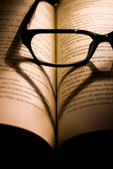 warm glassess, heart shape shadow on book