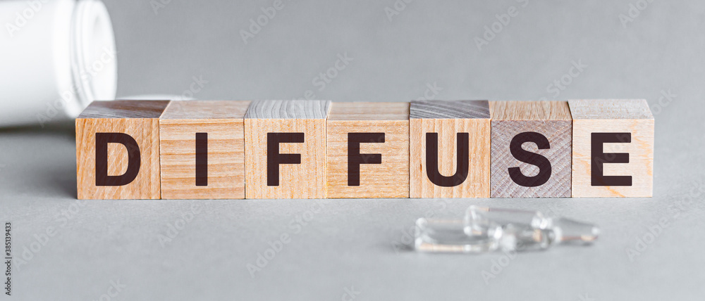 Poster diffuse is a word written in black letters on wooden cubes.