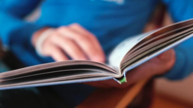 Turning the pages of a book in the library. A quick study of the content of the book for analysis. Pages fall from the side, explore books.