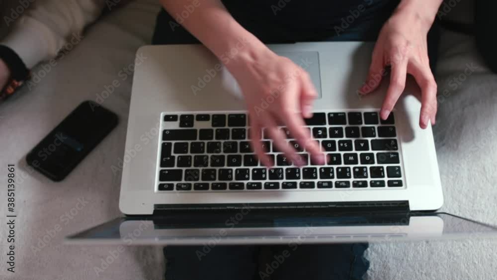Poster worker hands are typing text on the laptop keyboard. reflex of anger at work. preparation of a text 