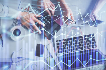 Double exposure of man and woman working together and financial chart hologram drawing. market analysis concept. Computer background. Top View.