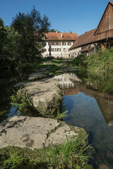 Fototapeta premium little river with a historic mill building
