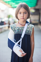 young, sad girl with a plaster cast