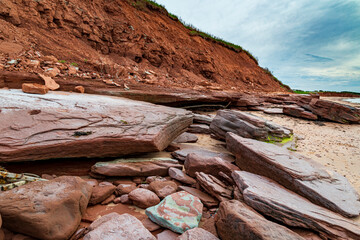 Red sandstone cliff and rocks at Cavendish beach of Prince Edward Island