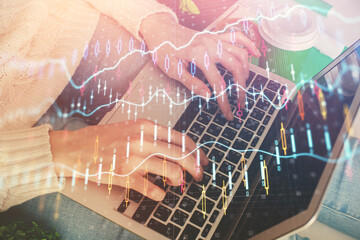 Double exposure of woman hands typing on computer and forex chart hologram drawing. Stock market invest concept.