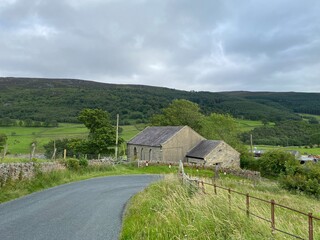 Looking across, New Road, toward farms, fields and forests on the horizon near, Appletreewick, Skipton, UK