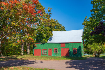 Old Barn in Rural Nova Scotia - Old barn on an early day in autumn in the rural countryside of Nova Scotia, Canada. The leaves of the trees are starting to show their autumn colors.