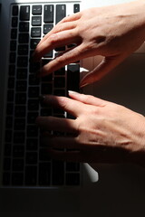 Woman typing on a laptop 