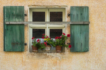 Fototapeta na wymiar window with flowers and shutters
