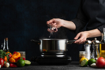 The professional chef out boiled octopus with a spoon from the pot. Backstage of cooking seafood...