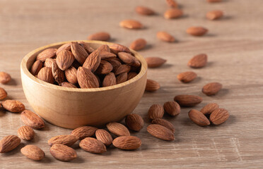 Almonds in a bowl on wood  table
.