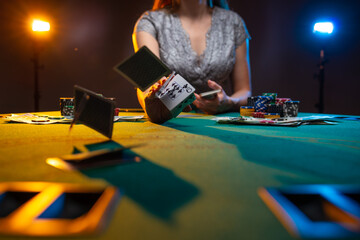 Flying poker cards above the casino table with gamer girl background. Gambling concept. Night life....