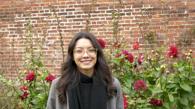 Portrait of a beautiful young asian american woman in a rose garden