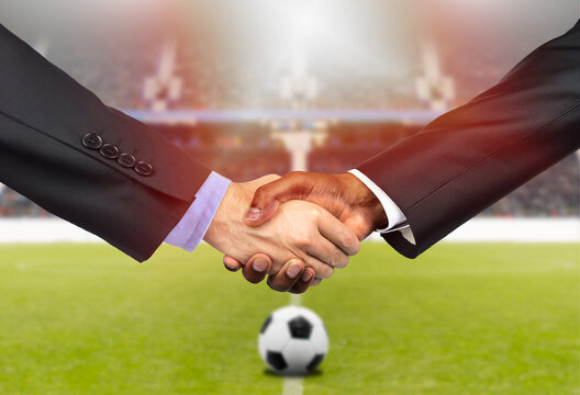 Cropped shot of two business people shaking hands together indoors on the soccer court