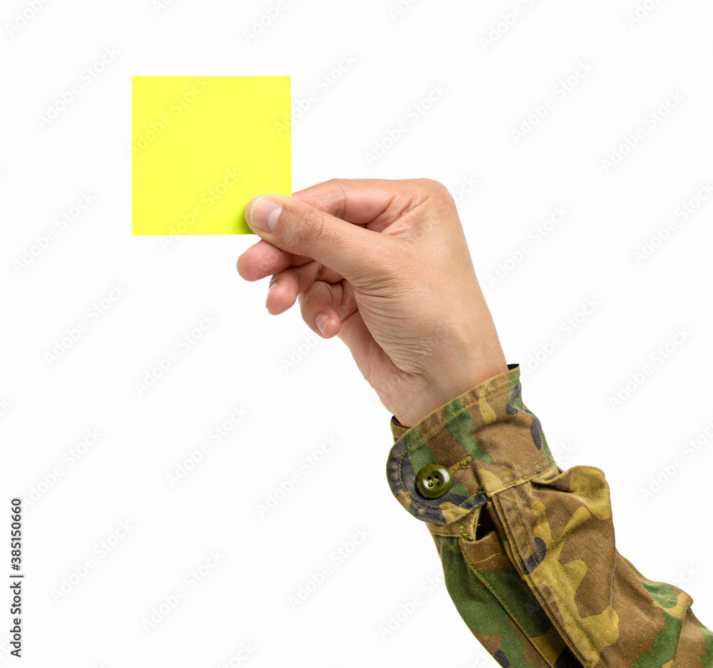 Wall mural Cropped shot of an unrecognizable man hand holding a yellow notepaper on a white isolated background