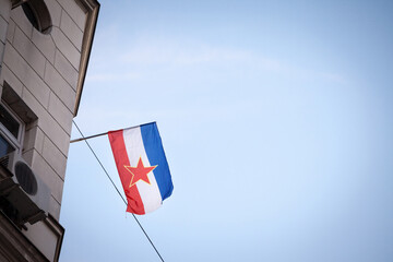 Yugoslav flag, with the red star of the communist socialist federal republic of yugoslavia (SFRY), waving in Belgrade, the former capital city of this disappeared state.