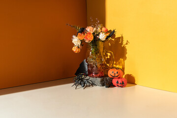 Funny Halloween day decoration party. Glass mug skull on an orange background.
