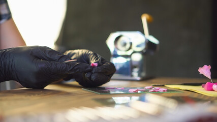 Hobby concept. Professional artisan works with polymer clay at workshop. Woman creates plastic...