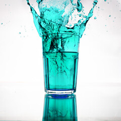 splash from a glass with blue water