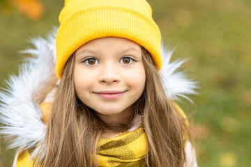 Portrait of a little girl in a yellow hat.
