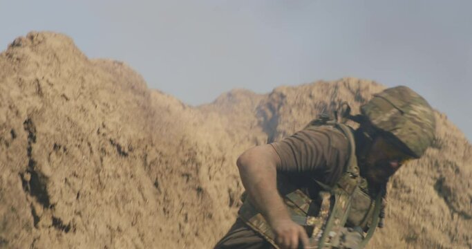 Male soldier hiding from blast in trench