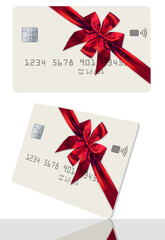 Here is a credit card or gift card decorated with a red bow and ribbon for Christmas.