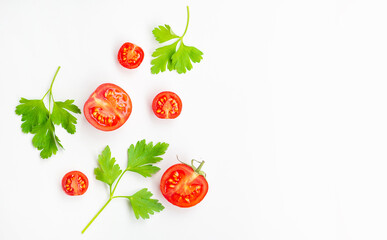 Red cherry tomatoes and persil leaves on white