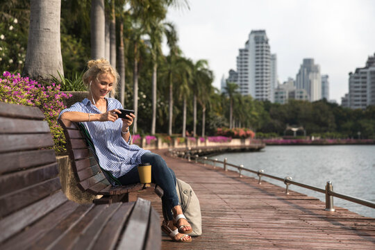 Attractive blonde woman using phone outdoors