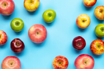 Ripe apples on blue background.