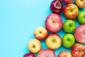 Ripe apples on blue background