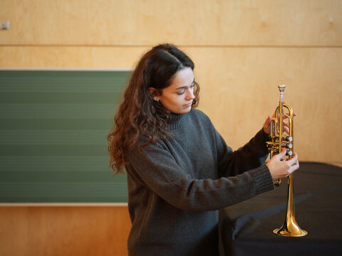 Young woman with trumpet in music class