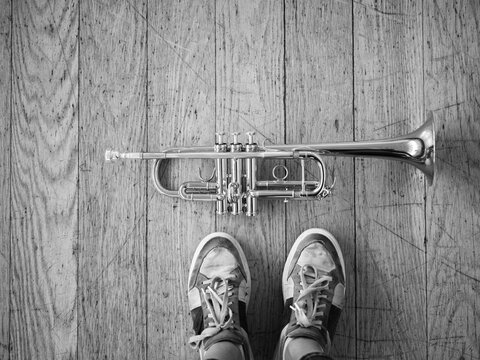 Trumpet and feet still on wooden floor